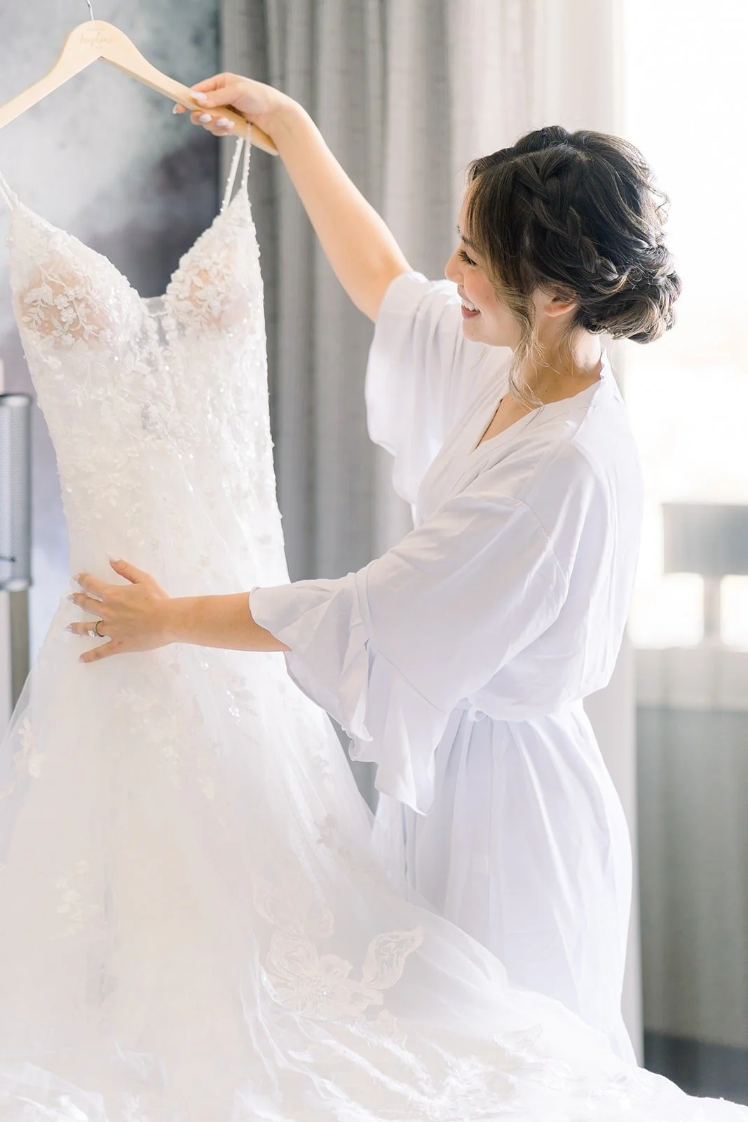 Josephine reaching for her lace gown on its hanger