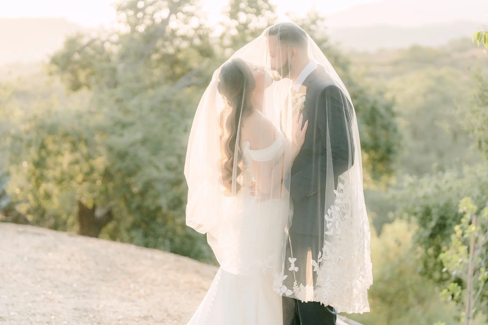 Mariana and Danny under her veil with the Claremont hills behind them
