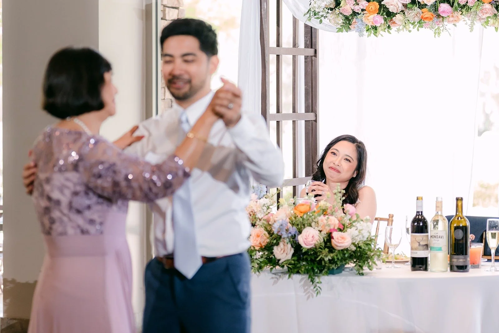 Mark and his mom dancing beside the sweetheart table