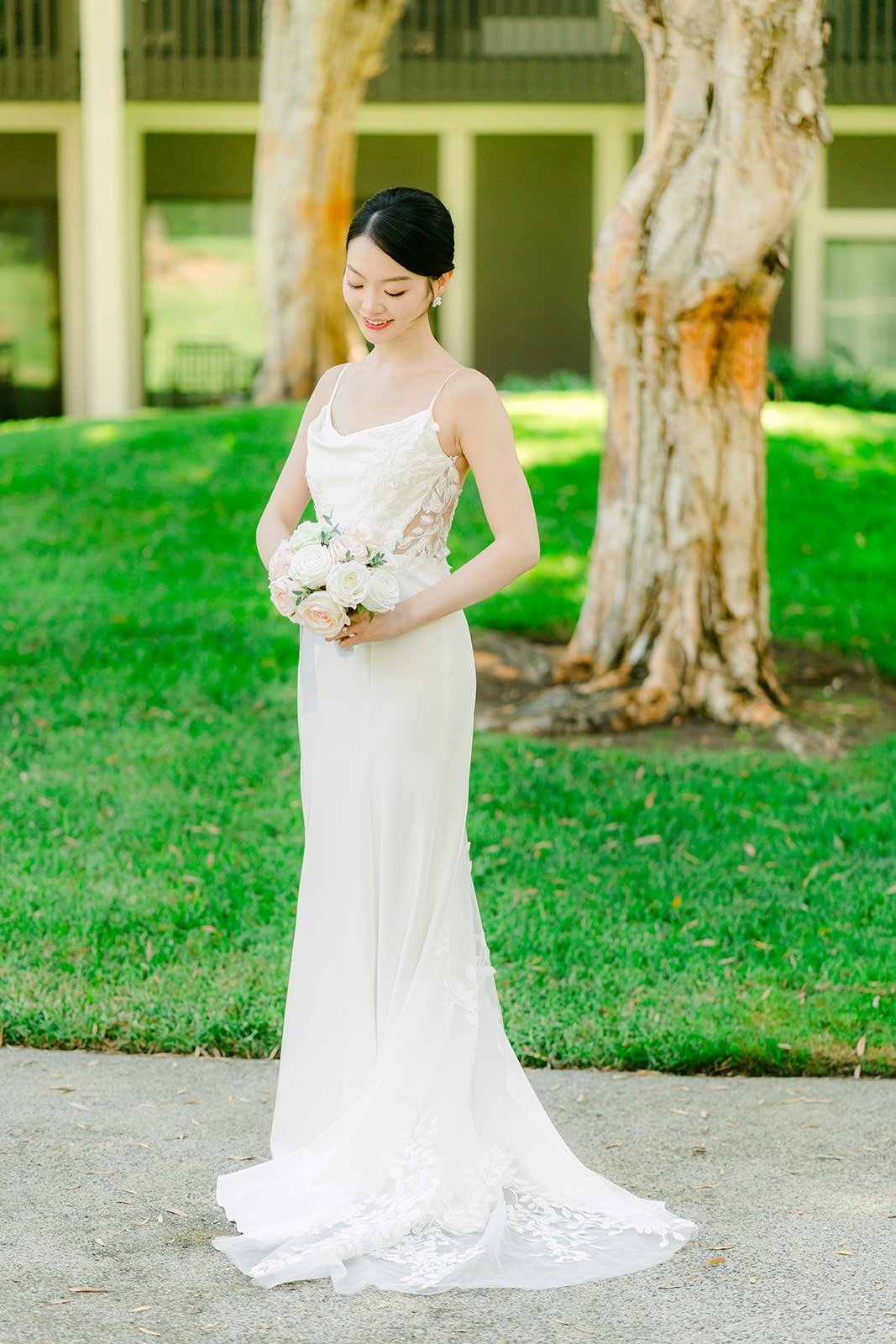 Tin in her dress on the lawn under the trees at Carlsbad Windmill