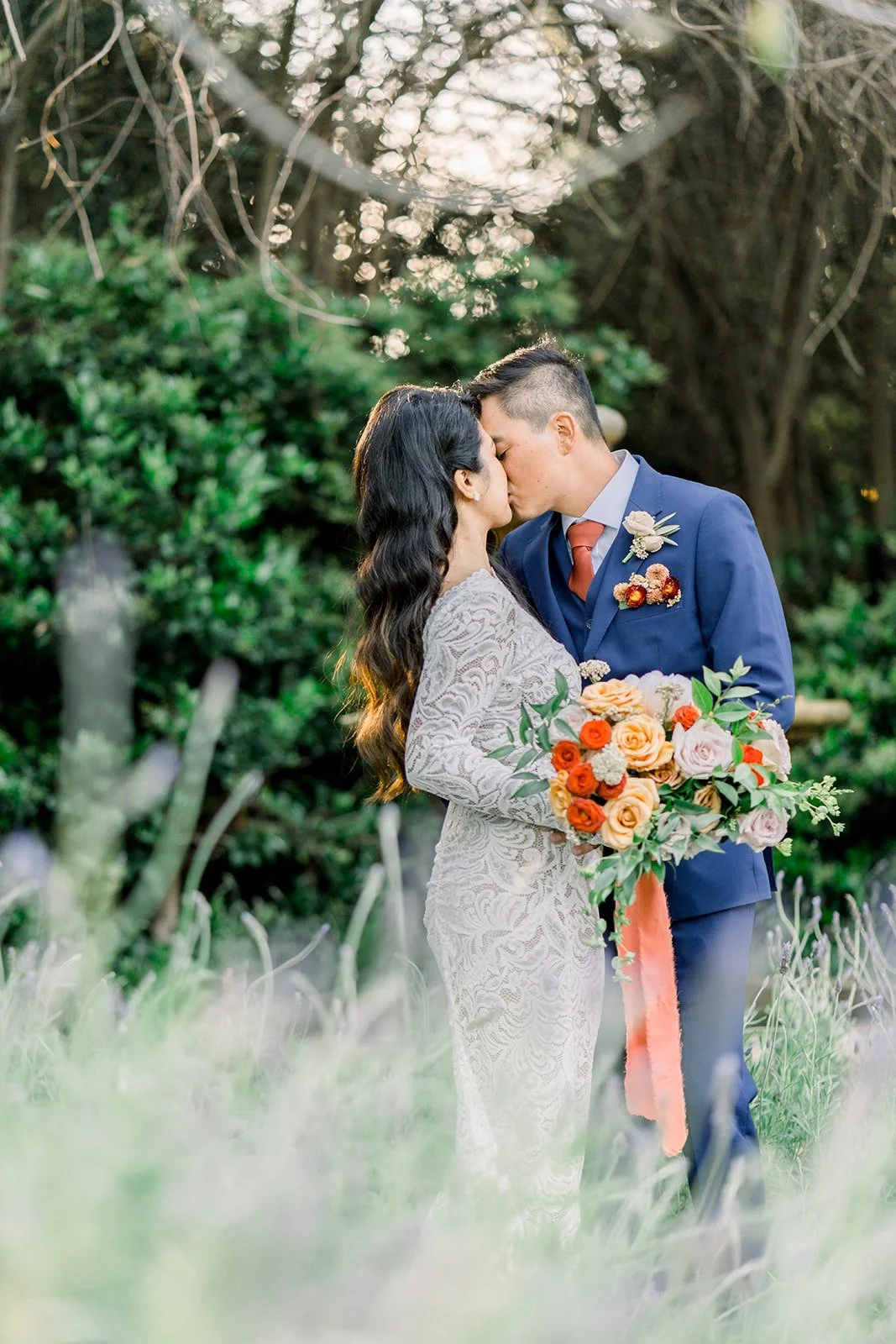 Hannah and Vincent sharing a kiss in the garden