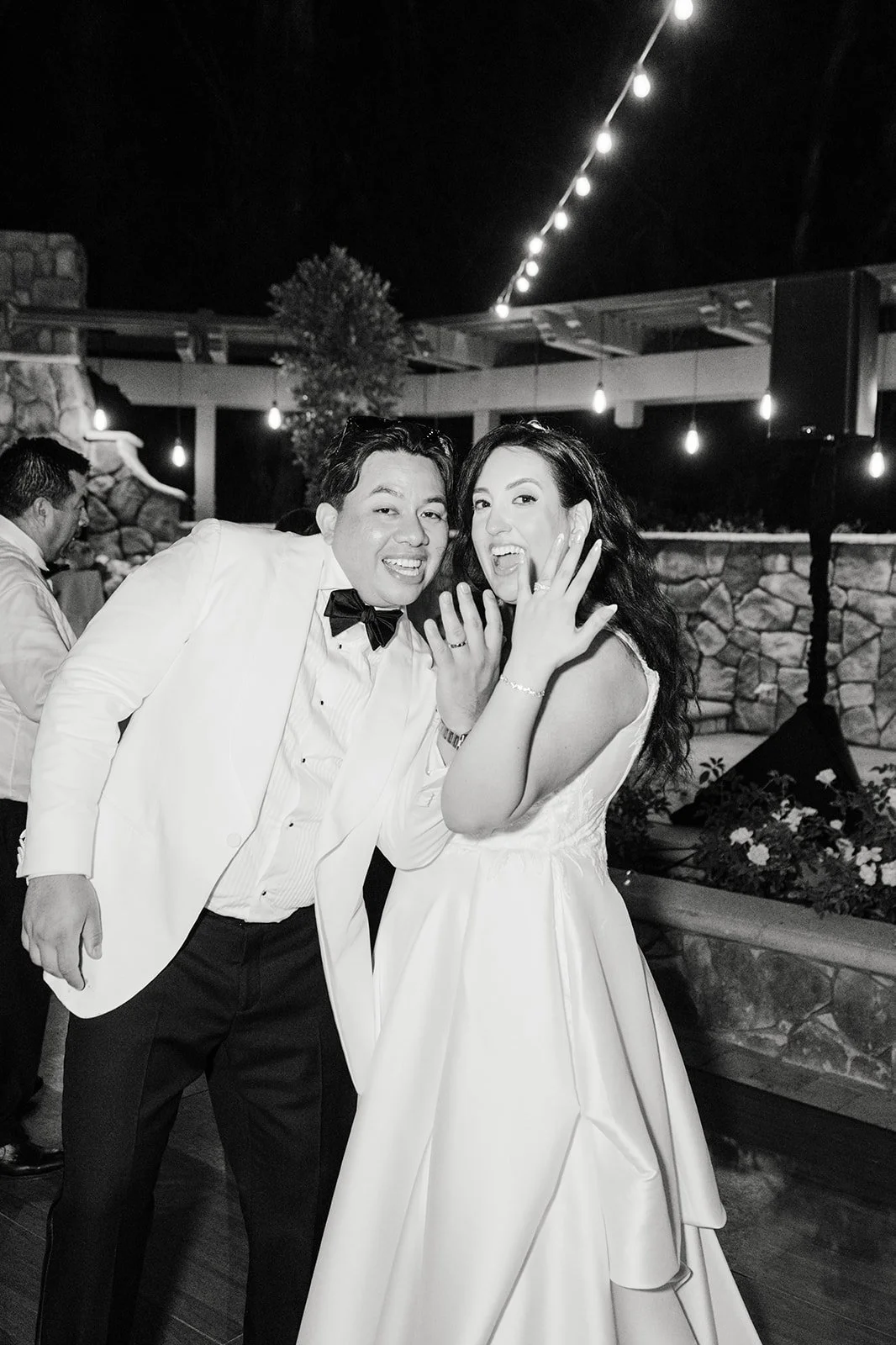 Black and white photo of the couple laughing at night