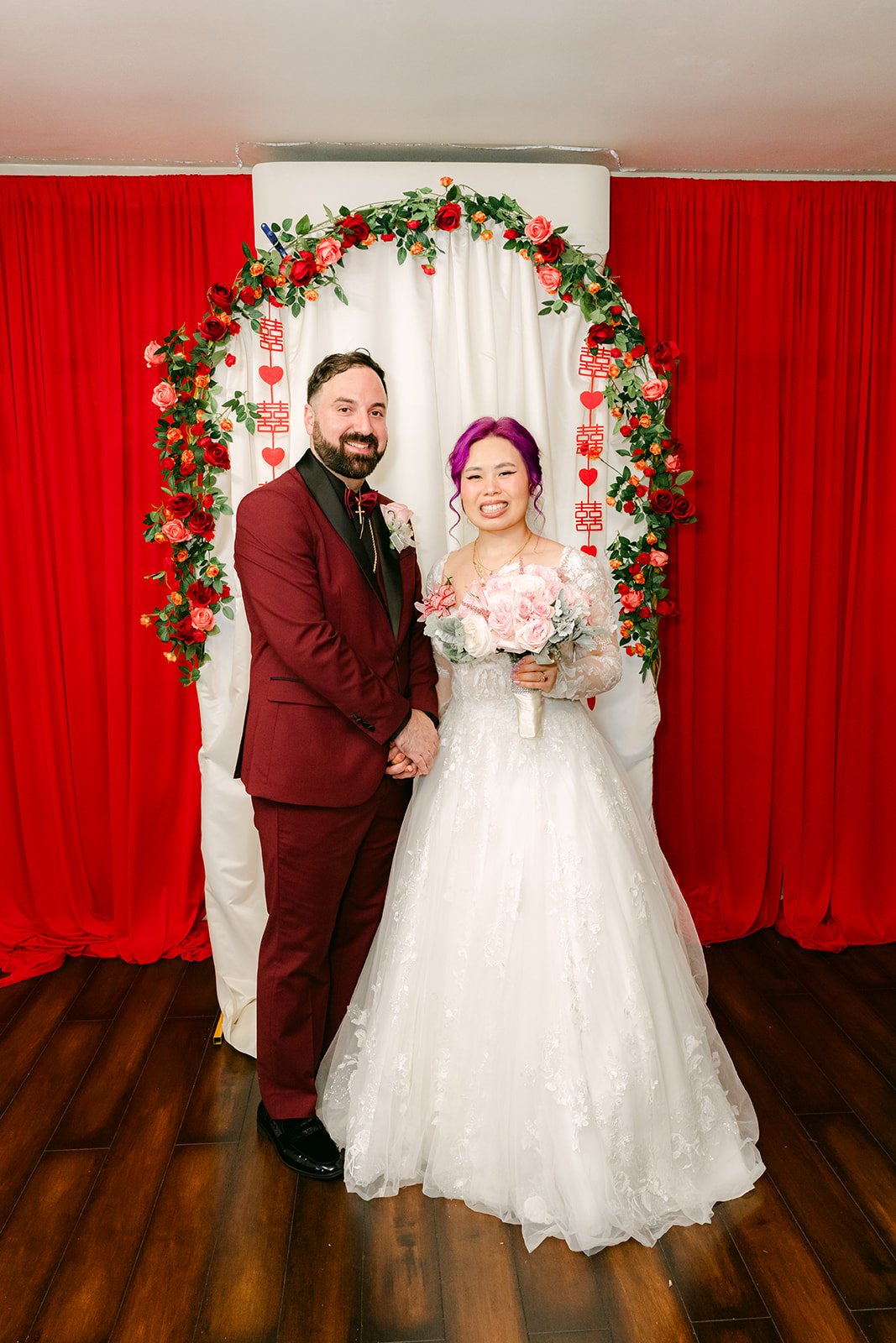 Vanessa and Ryan smiling together under the arch.
