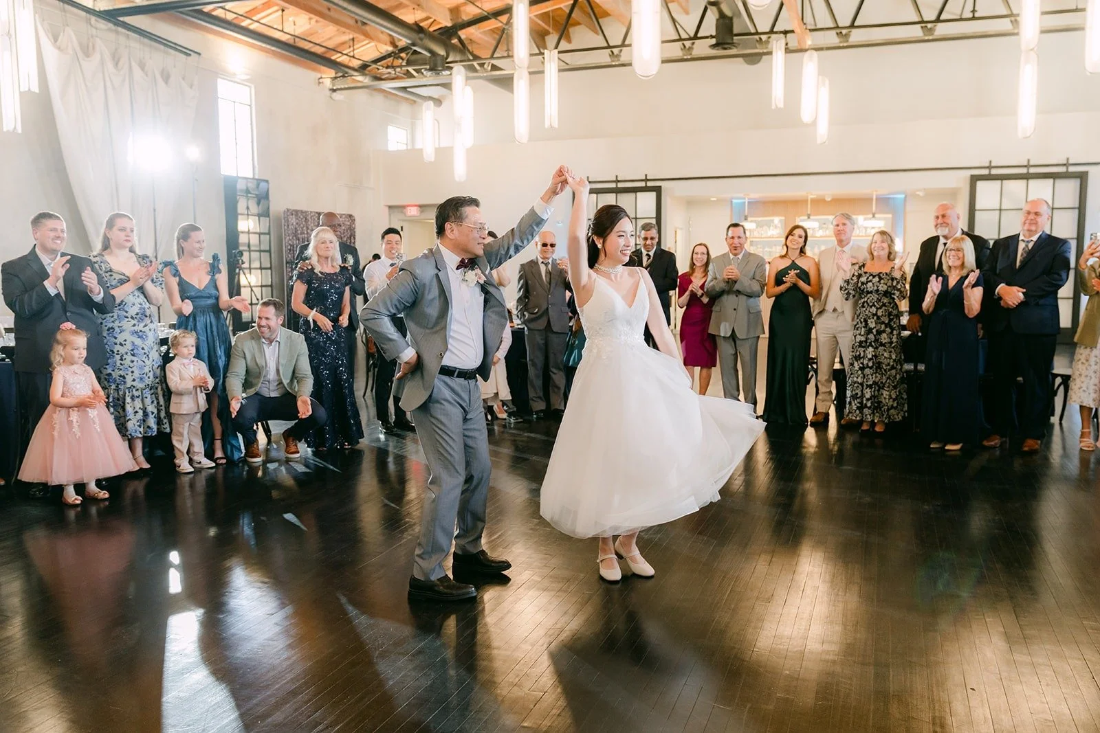 Elisa and Brandon start their first dance as guests look on
