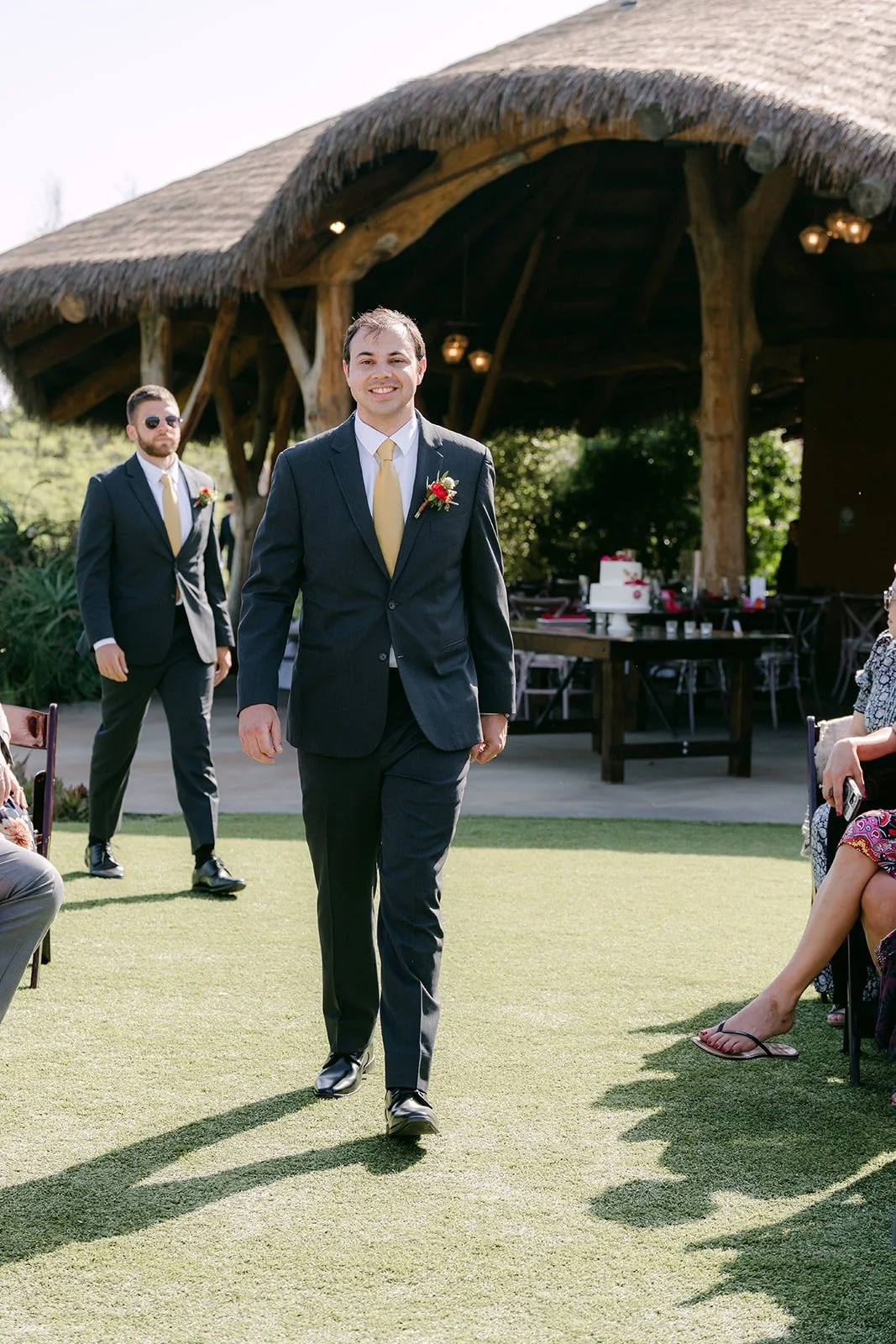 Zach walking down the aisle on the lawn at Kijamii Overlook