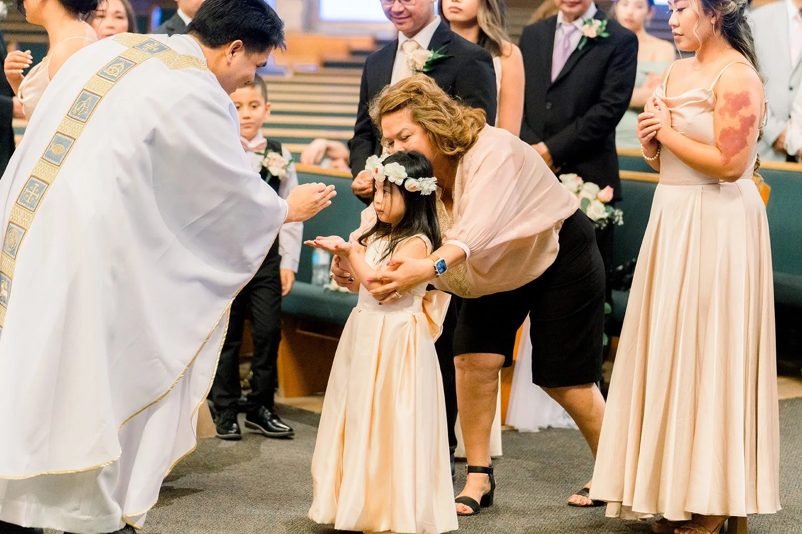 The priest blessing guests during the ceremony
