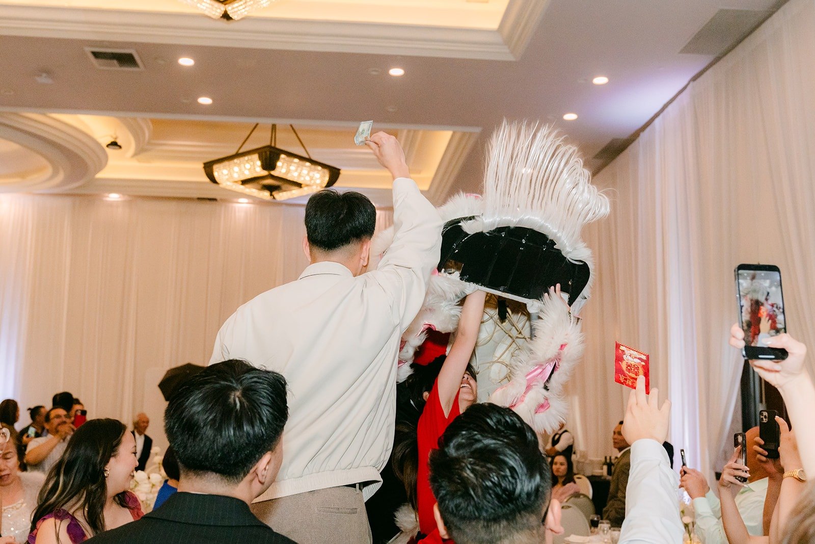 Lion dancers performing between the tables