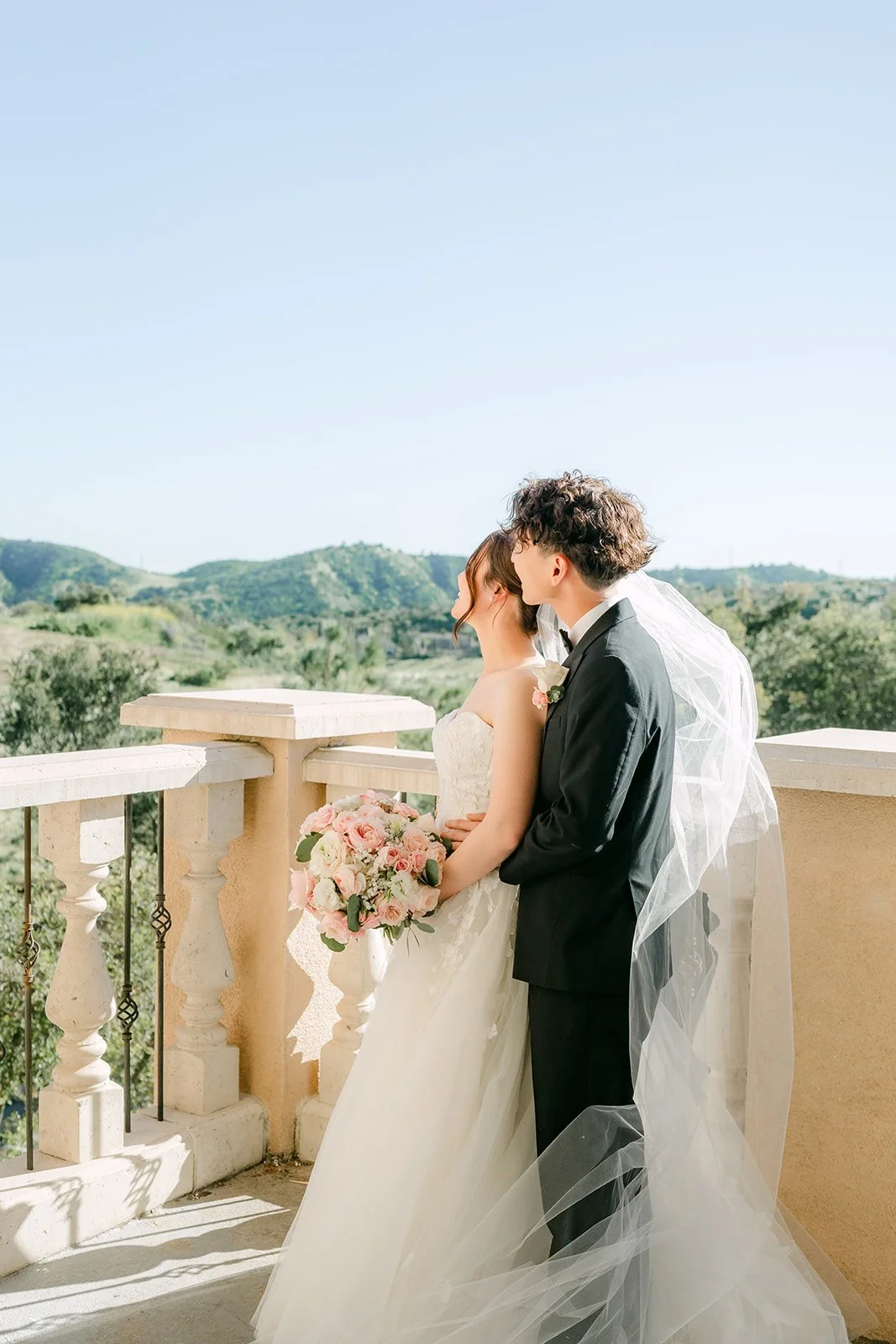 Couple embracing on the balcony overlooking the Chino Hills