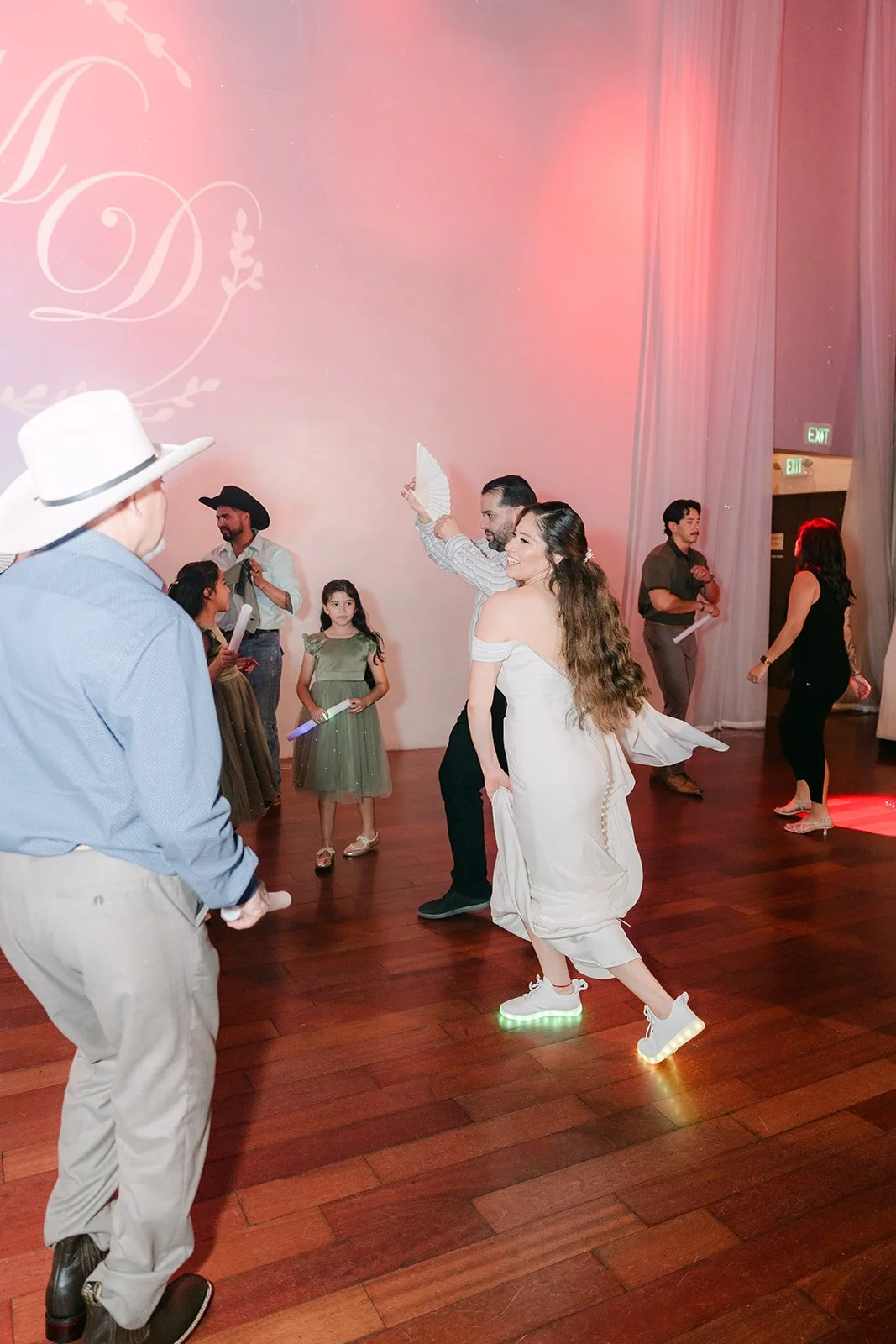 Mariana's dad in his cowboy hat dancing with guests