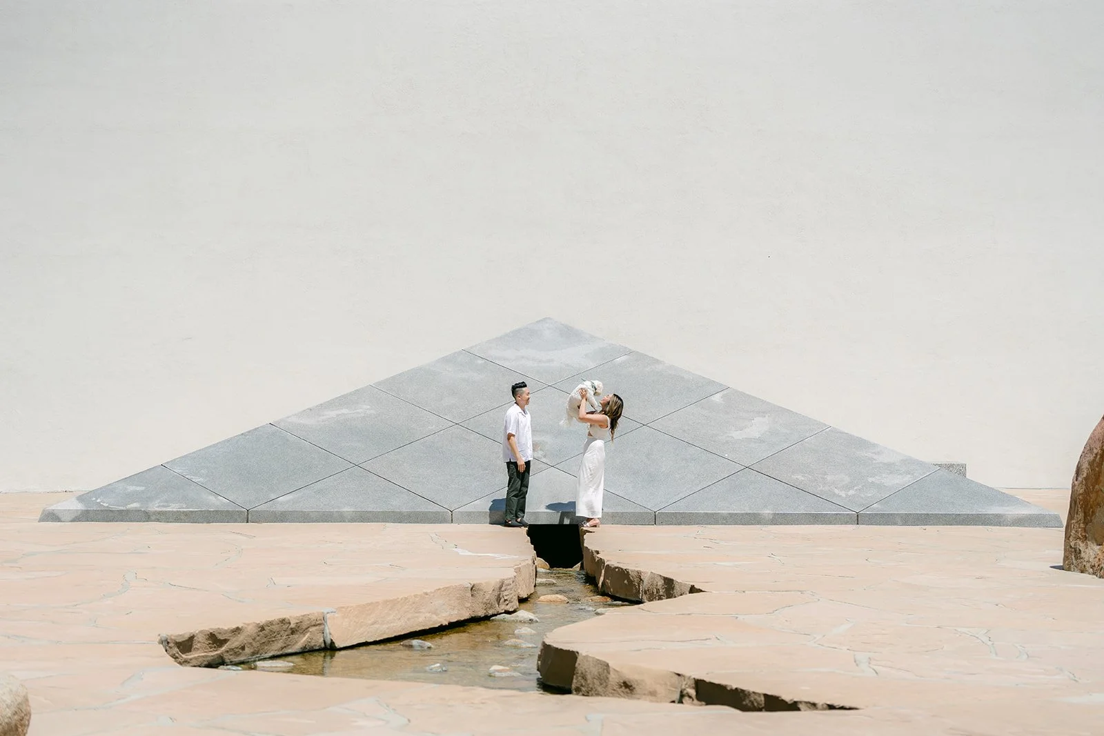 Stephanie, Alan and Tofu in front of the granite pyramid sculpture.