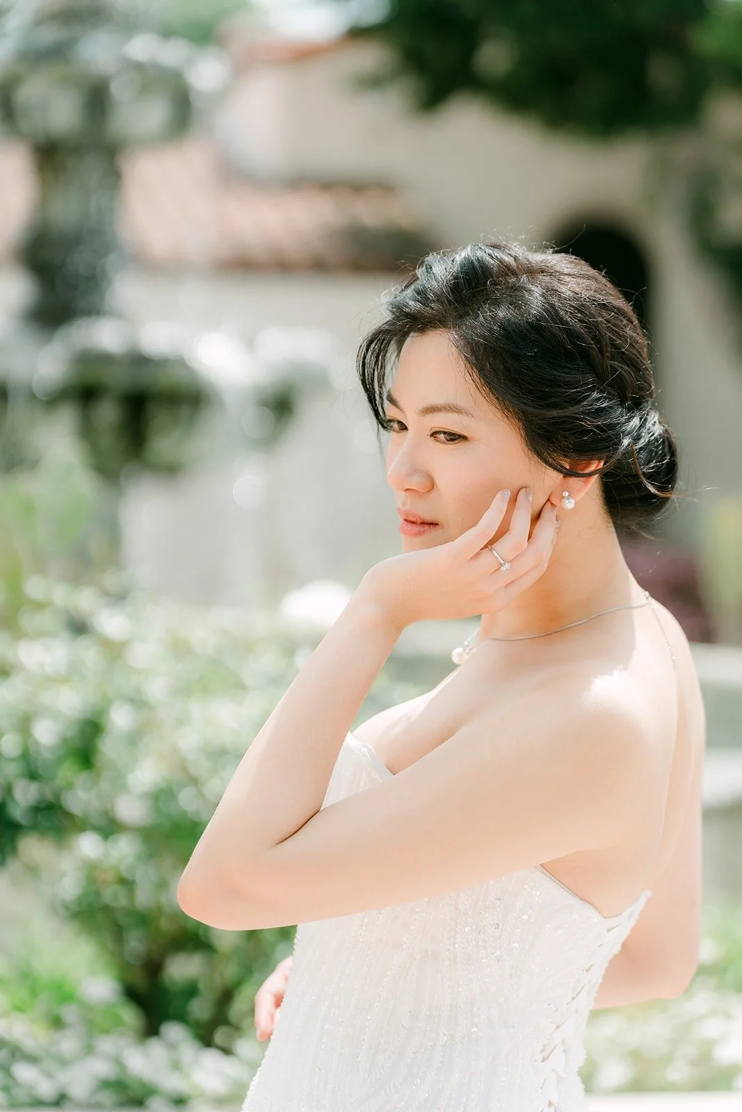Eunice in her strapless gown with her hand at her cheek