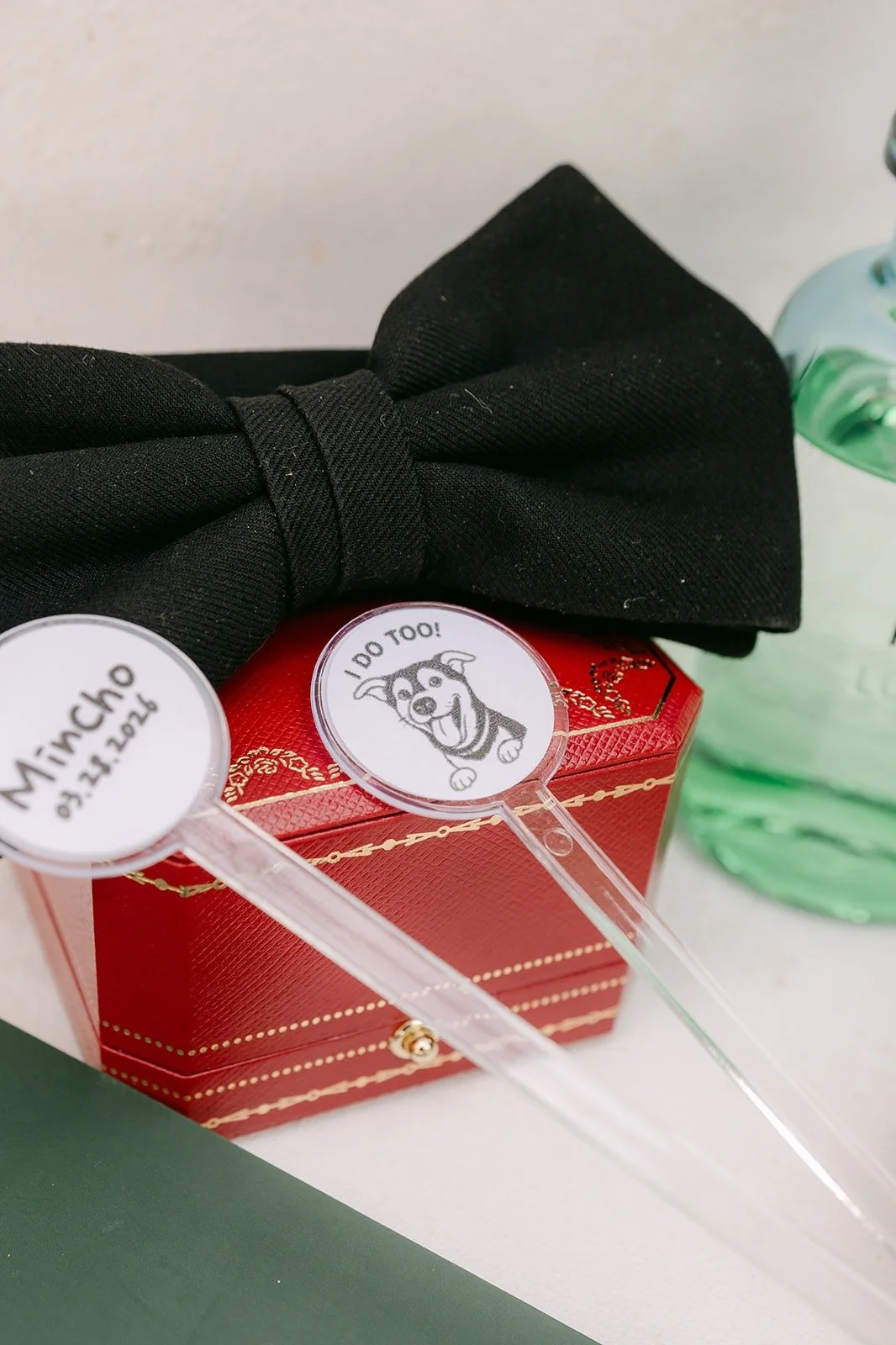 A black bow tie and a red ring box styled for Min Soo's wedding morning