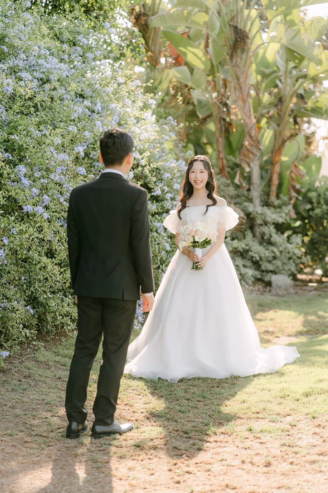 Eunsang facing Jeannie on the lawn for their first look