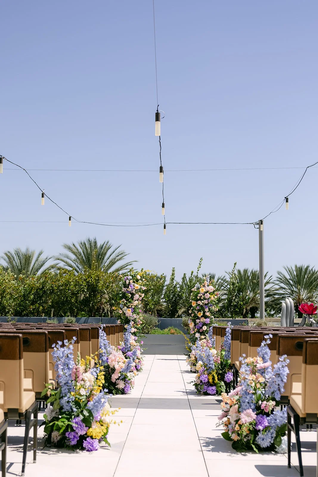 Serenity Garden ceremony aisle at JW Marriott Anaheim lined with blue and pastel florals