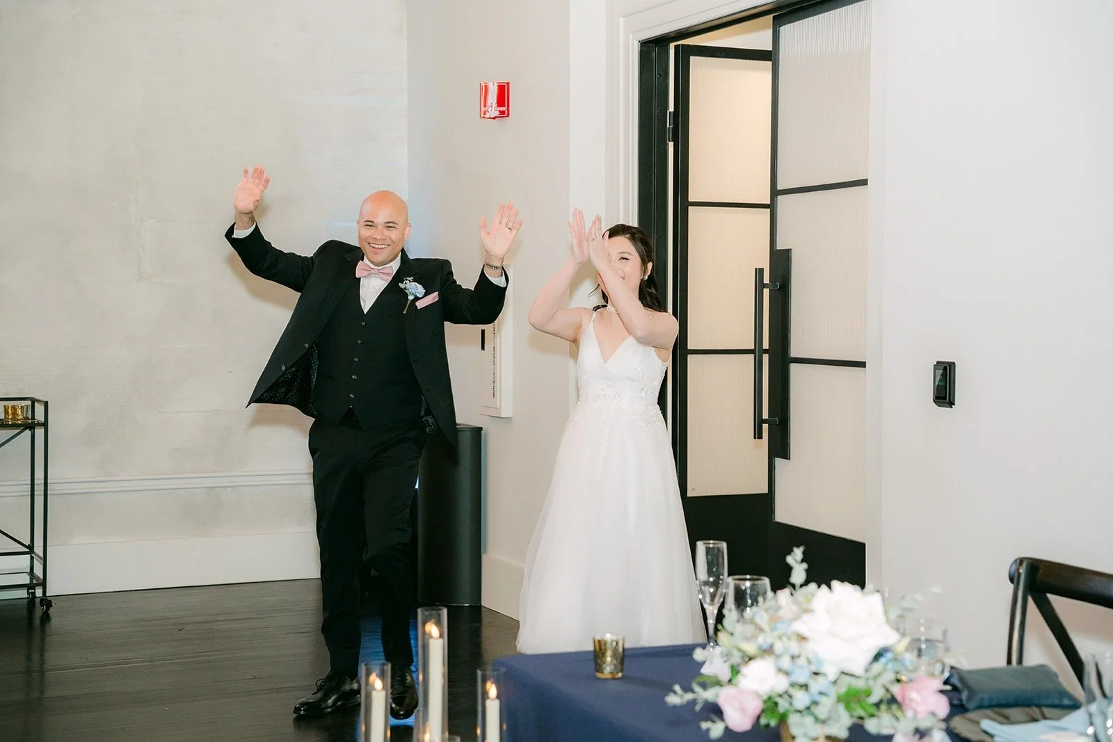Elisa and Brandon celebrate with their arms in the air