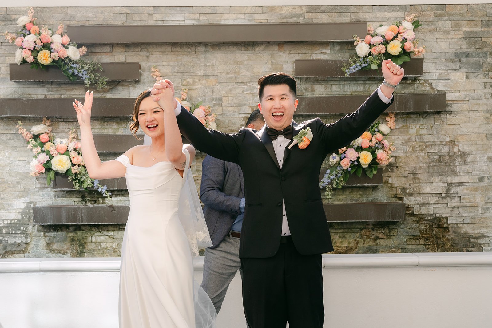 Amanda and San cheering after being pronounced married.
