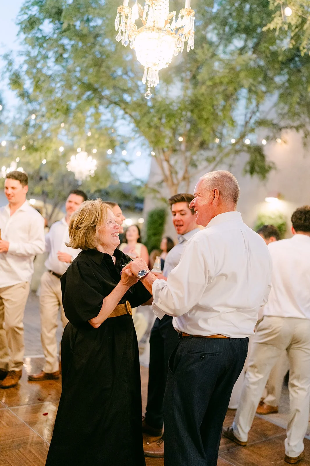 Guests dancing under the chandelier