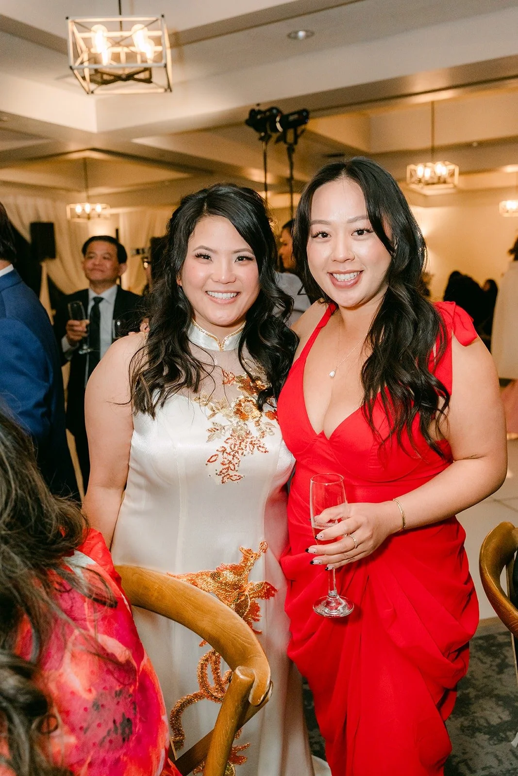 Florence in a white cheongsam with a guest in red