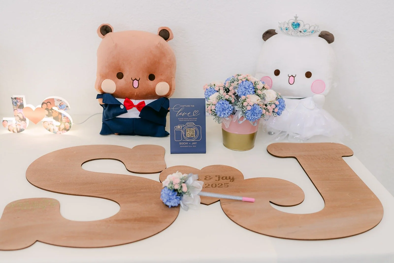 Two plush bears and wooden S and J letters on the reception table