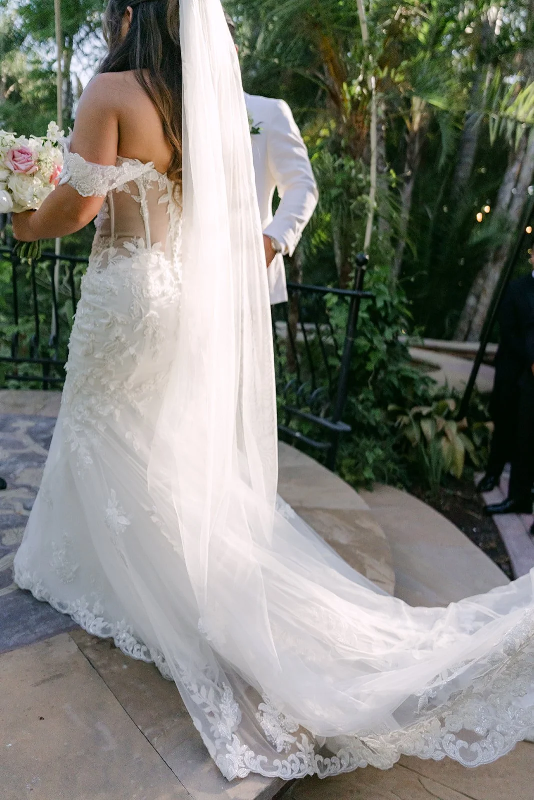 Nicole's cathedral veil trailing behind her at the ceremony.