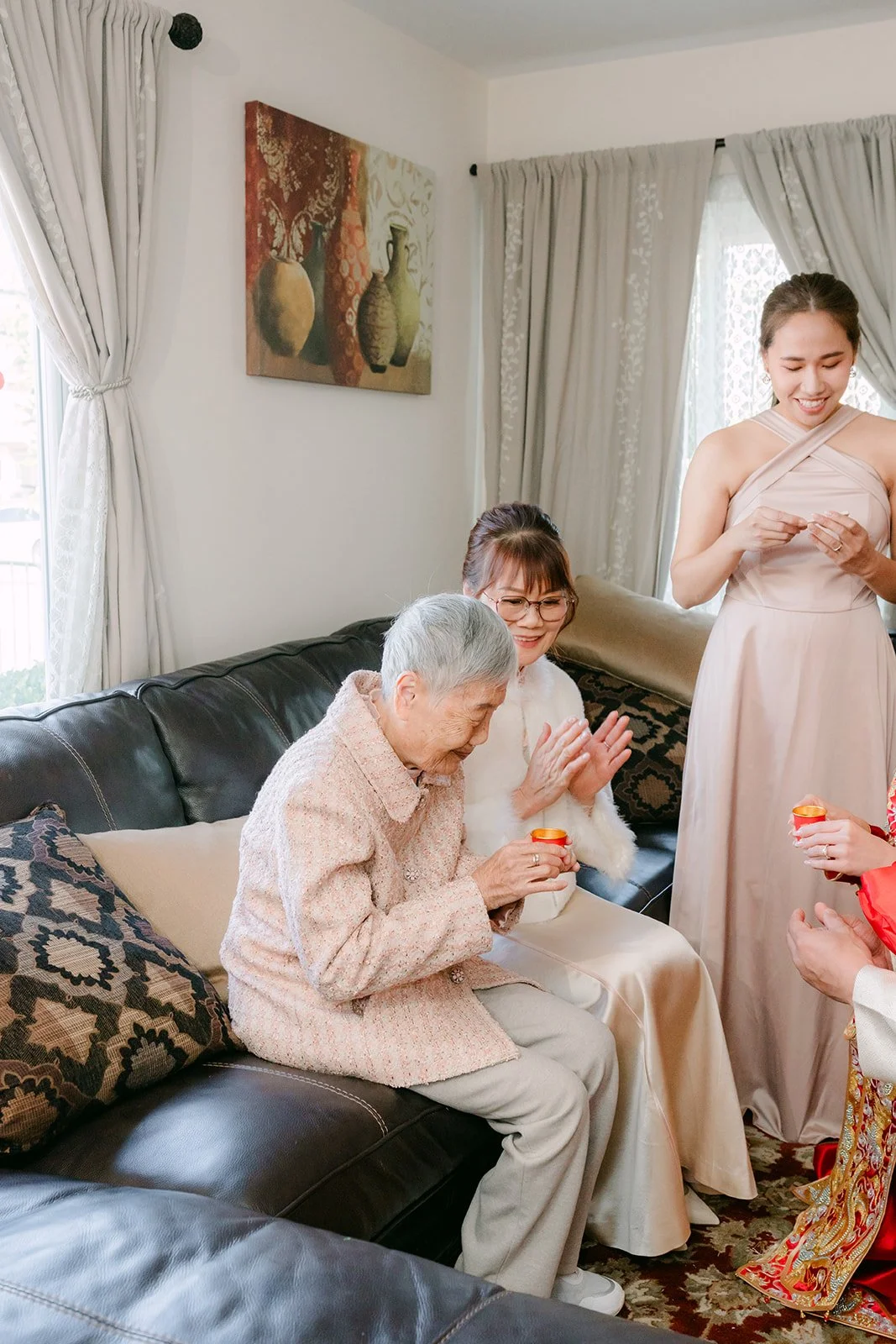A grandfather accepting tea from the couple during the tea ceremony.