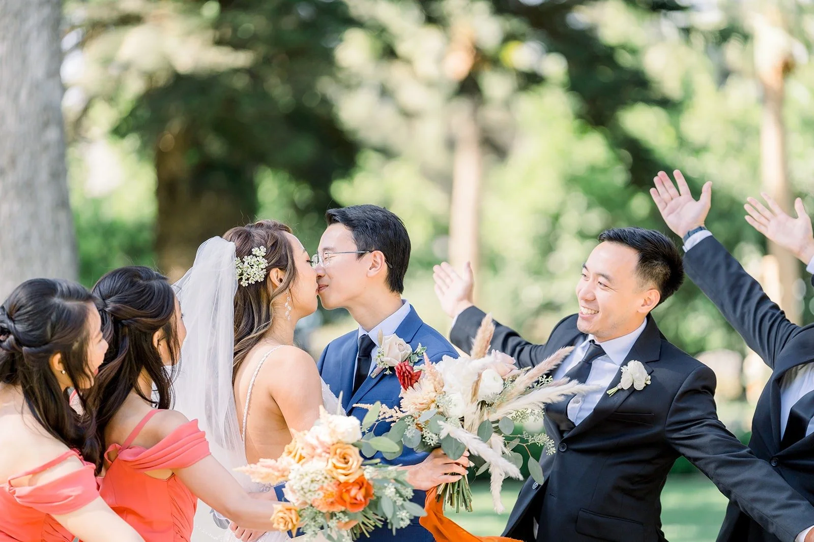 The wedding party cheering around Ariel and Alex