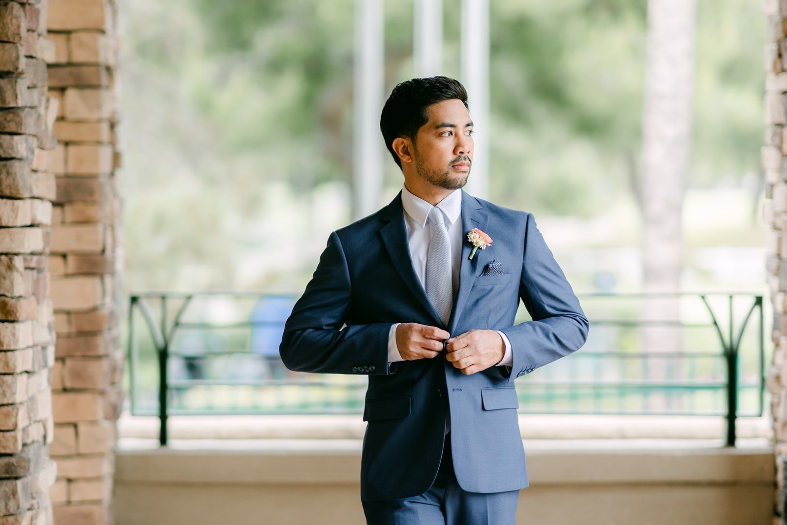 Mark buttoning his jacket on the terrace overlooking the golf course