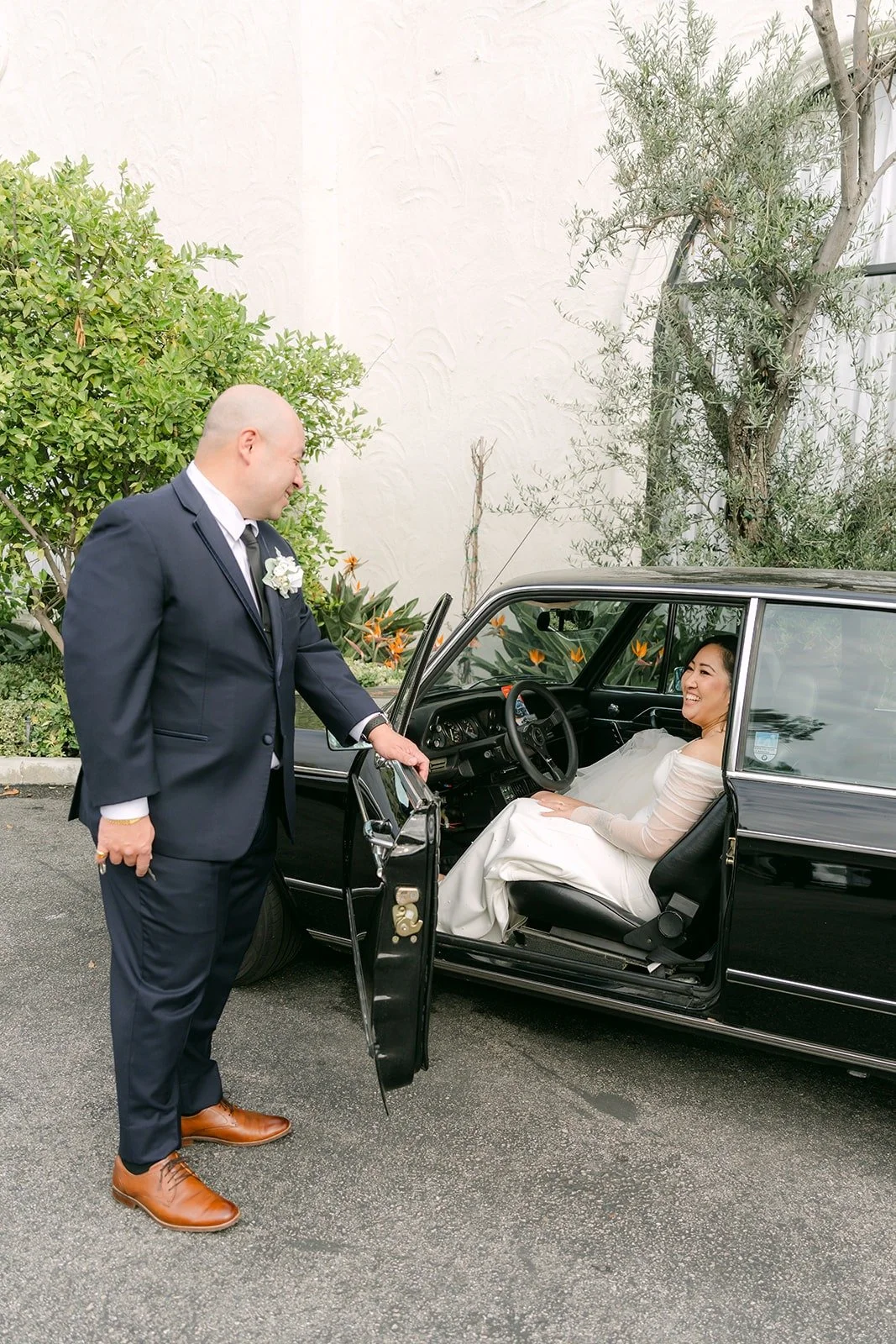 Yao opening the door of the vintage car for Vivian