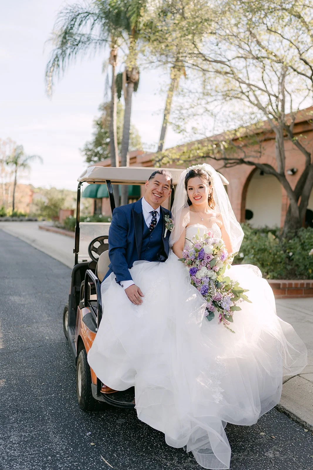 Kate and Michael posing with a classic car at Sierra La Verne.