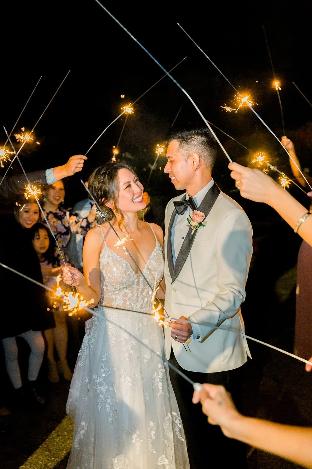 Josephine and David laughing under the sparklers