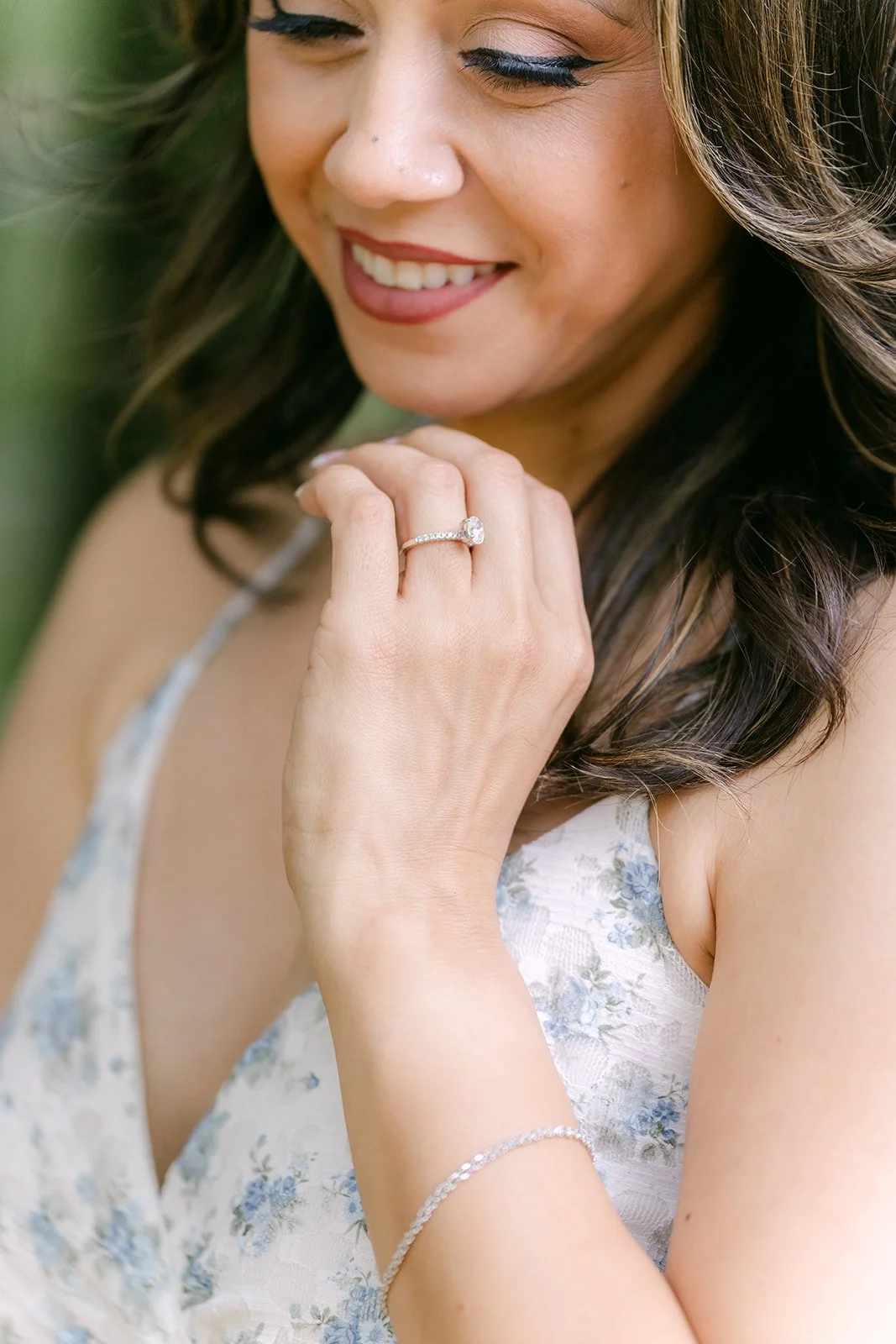 Close-up of Francesca smiling with her hand at her collarbone.