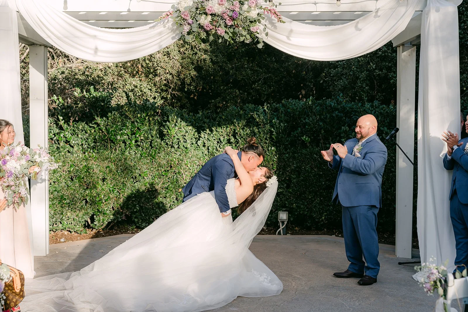 Michael dipping Kate for a kiss under the pergola.