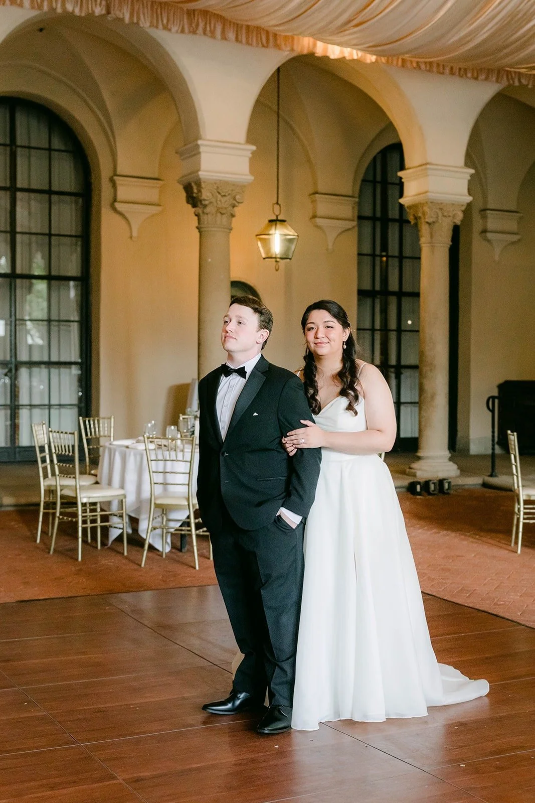 Matthew and Saira dancing between the reception tables