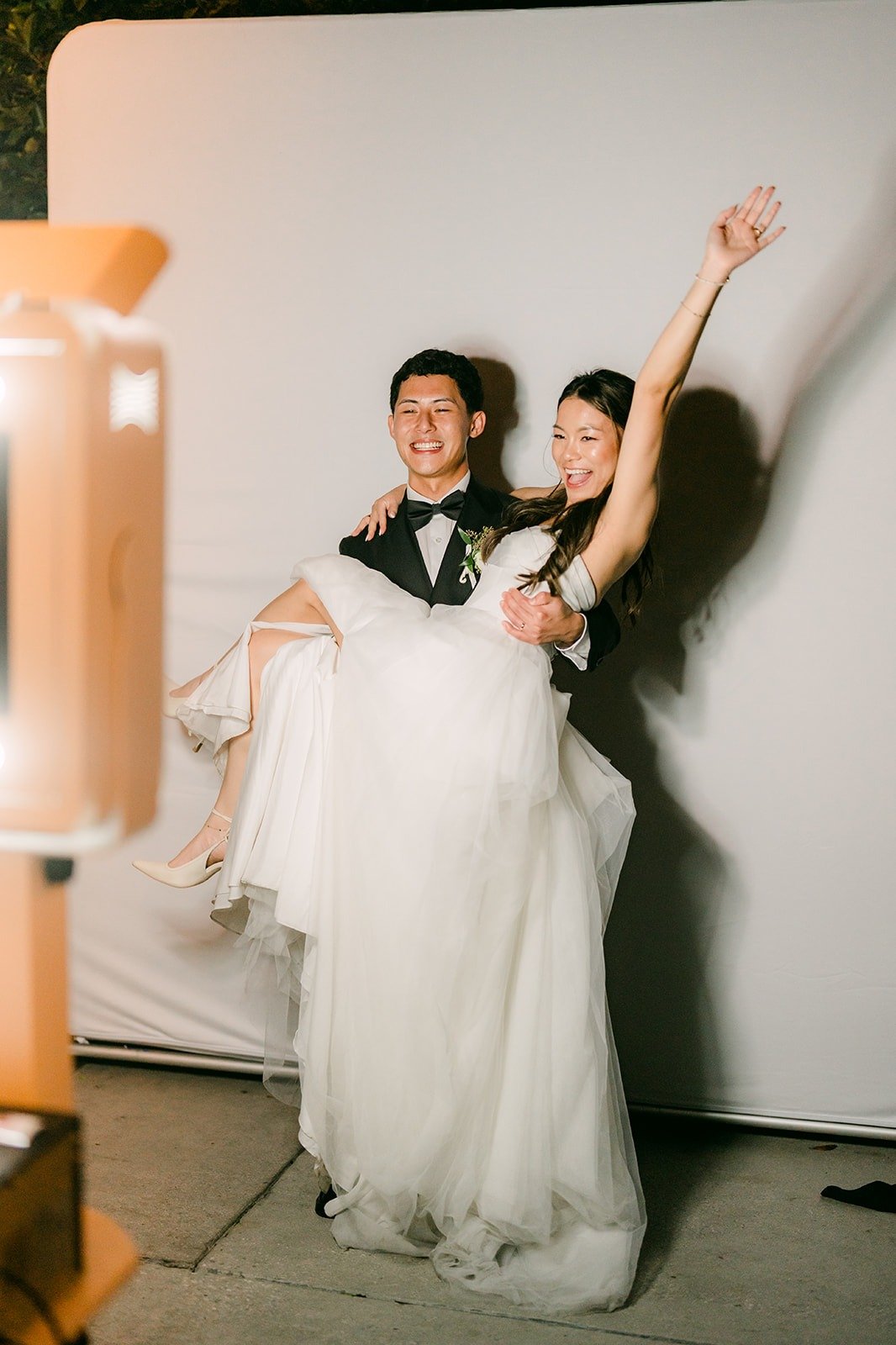 Richard carrying Jadee as she throws her arm up