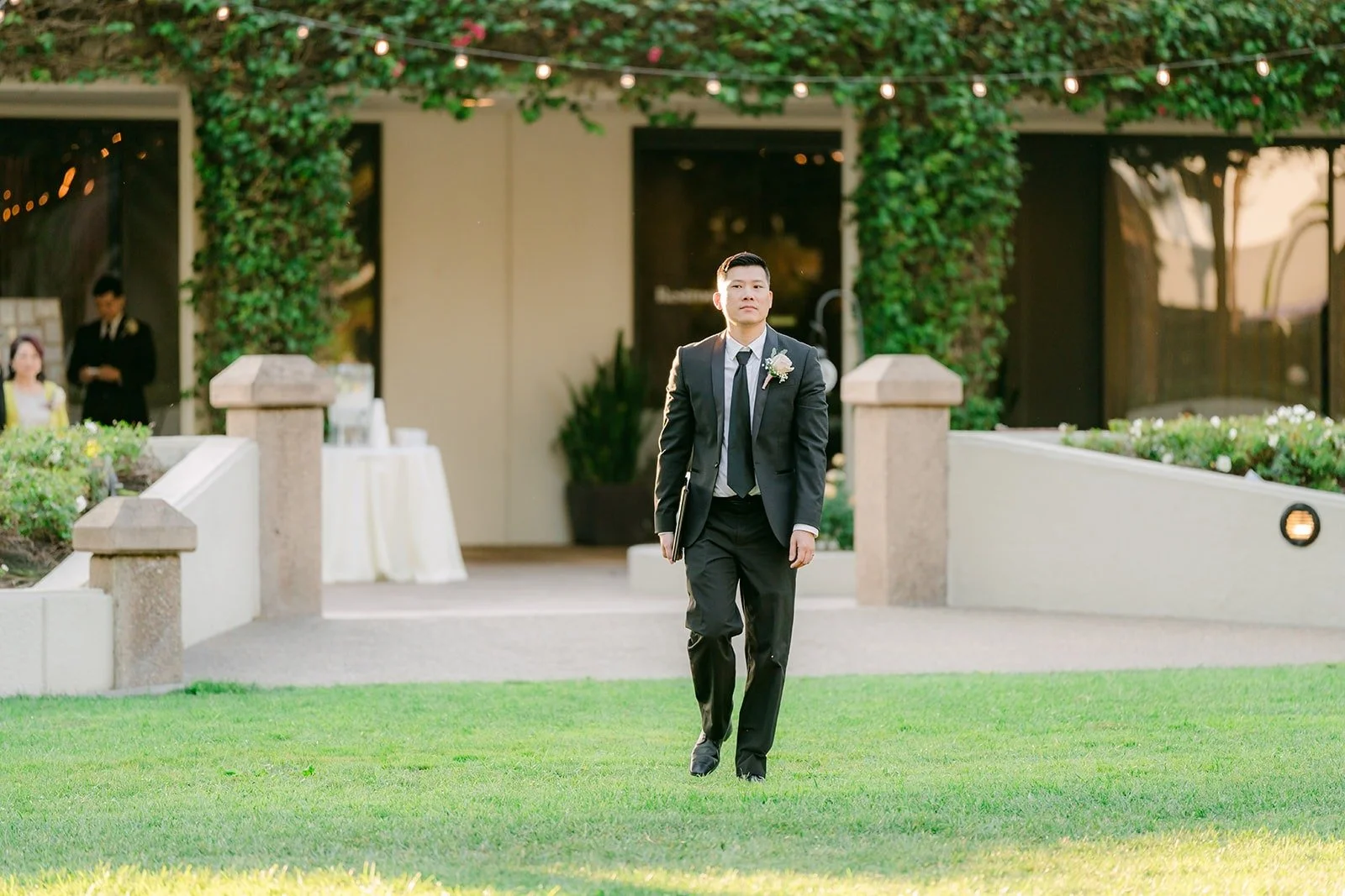 Alex walking down the aisle on the lawn