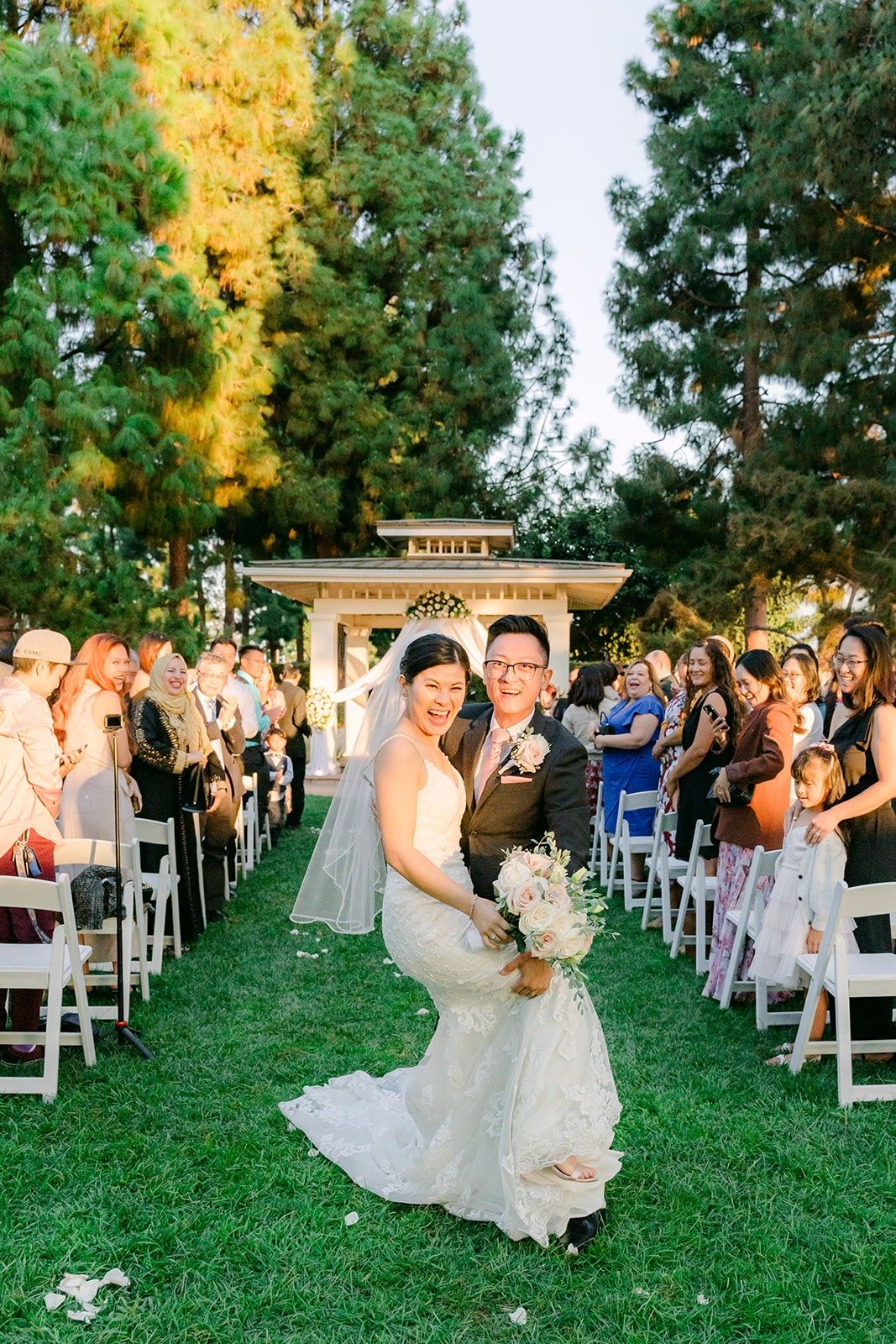 Xuemin and Alex recessing down the aisle as guests cheer