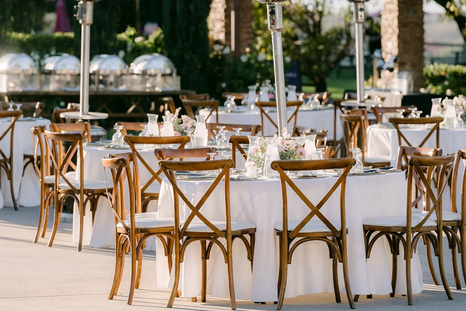 Long tables with cross back chairs set for the reception