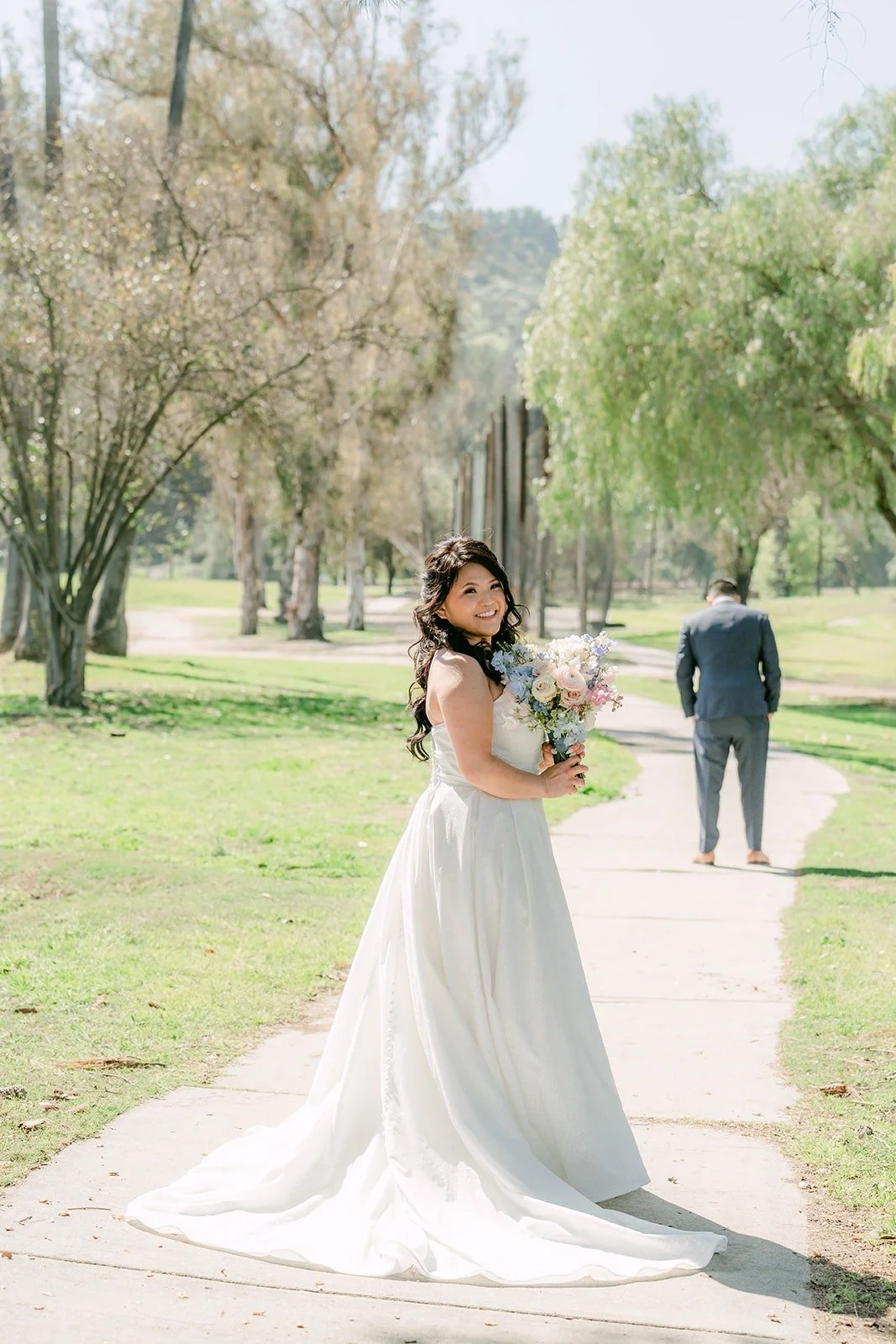 Florence walking up the path behind Jordan for their first look