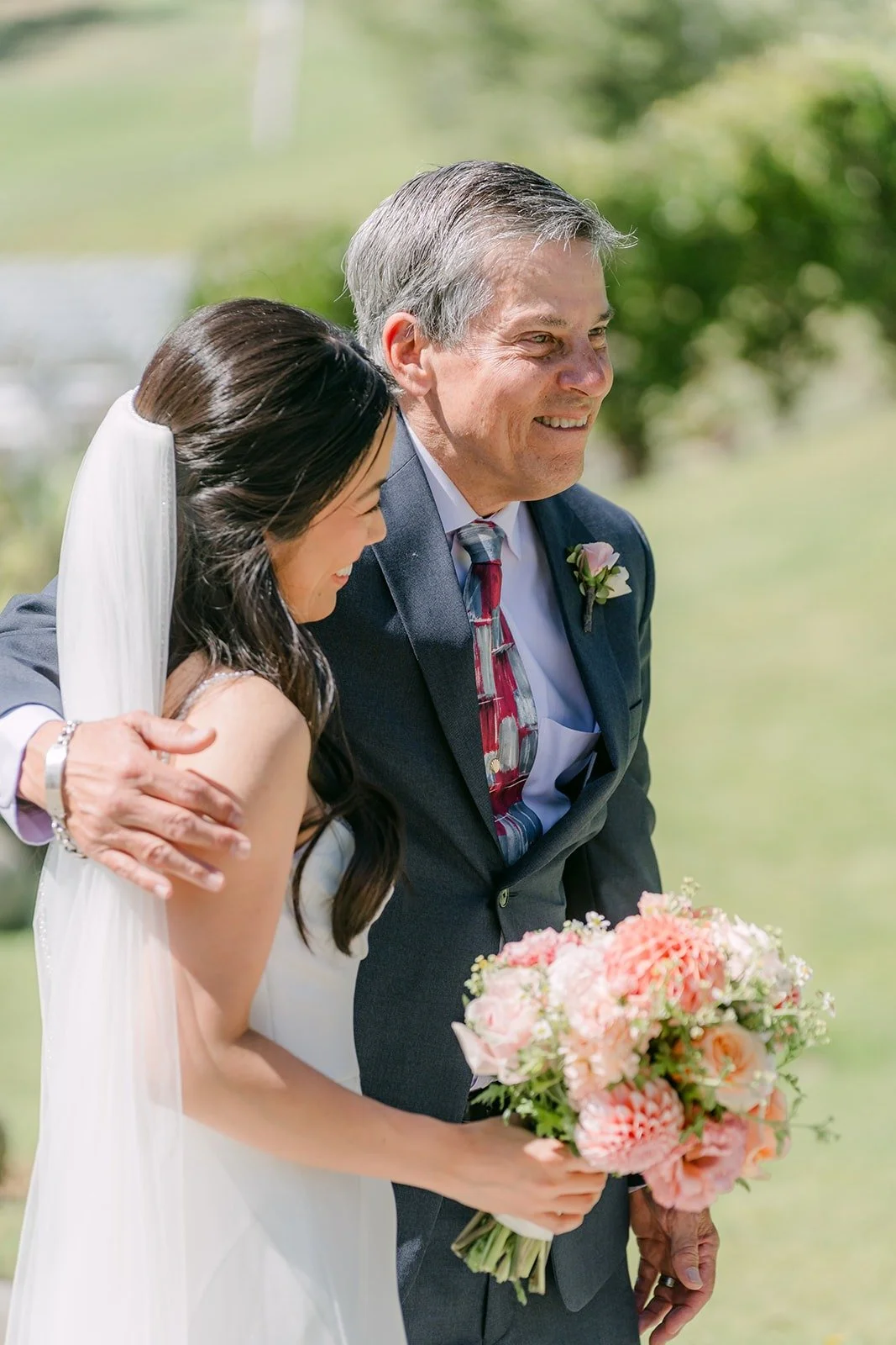 A warm hug between Stephanie and a family member after their first look, photographed by One and Only Production