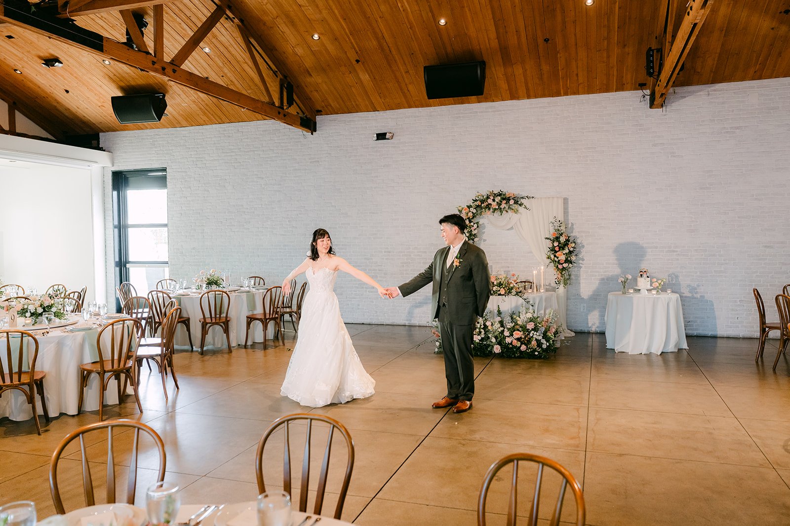 Wide view of the couple dancing in the Colony House Great Hall before guests arrived
