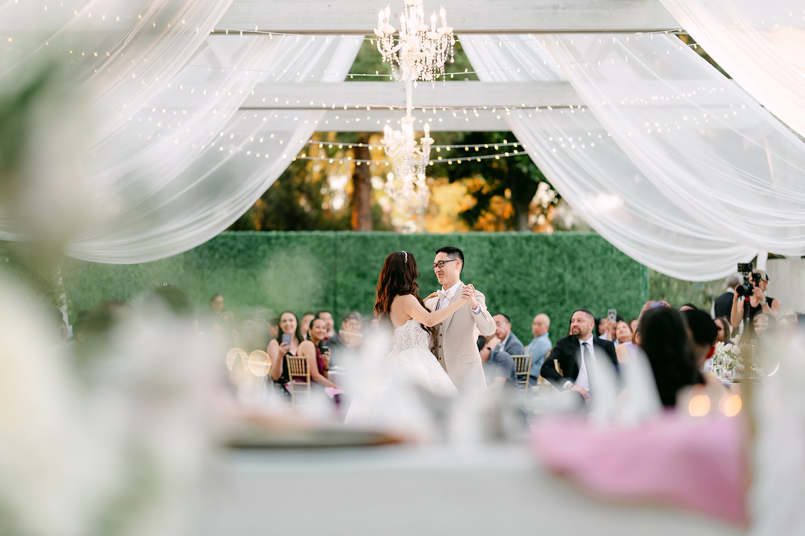 Sandra and Kevin dancing as guests watch from their tables.
