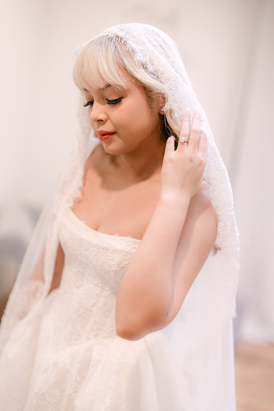 Konitha adjusting her lace edged veil