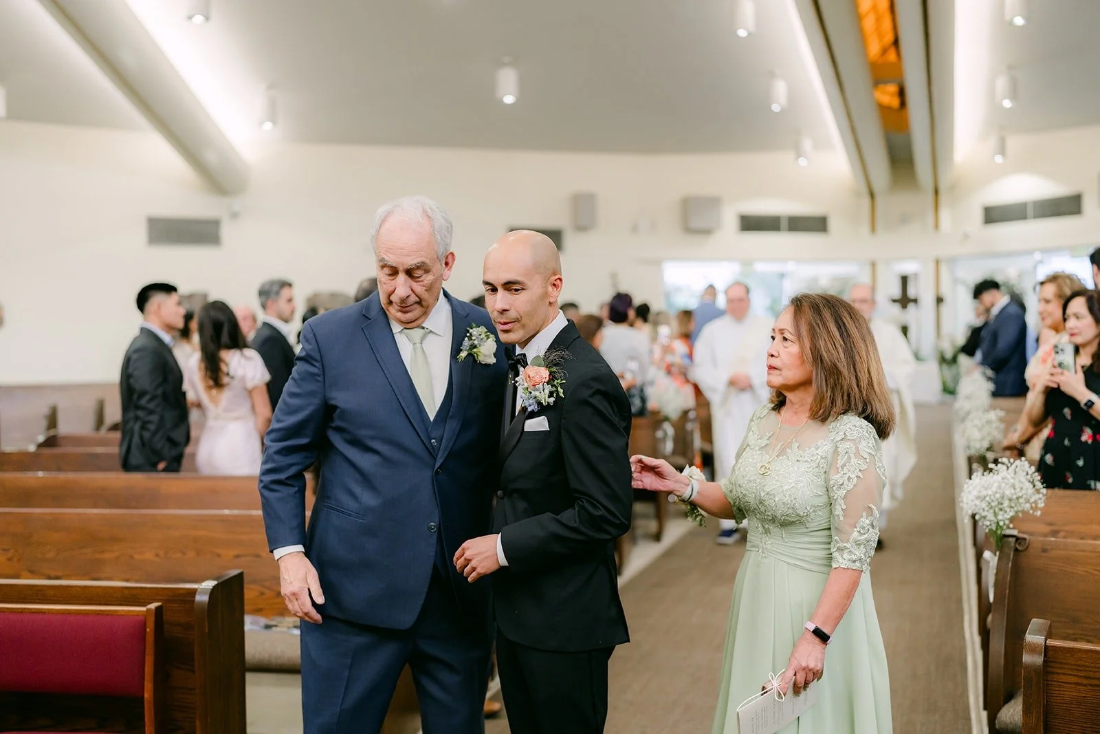 Daniel walks down the aisle with family members at Beatitudes of Our Lord