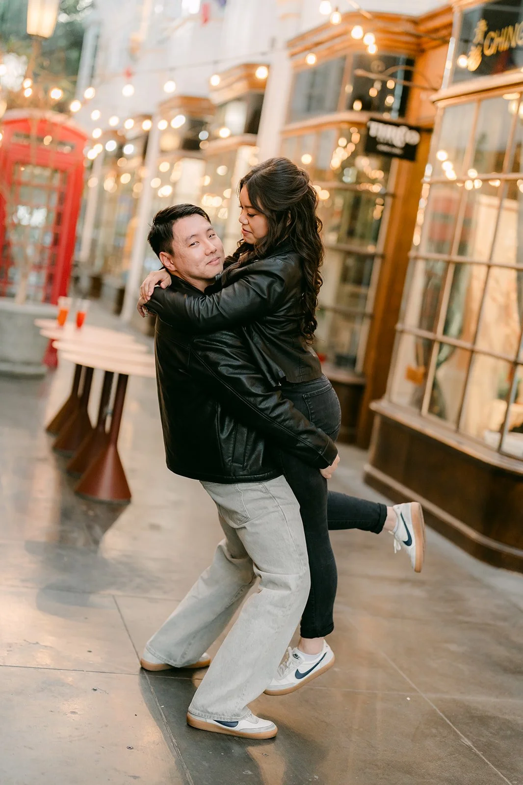 Emily and James dance beside the red phone booth.