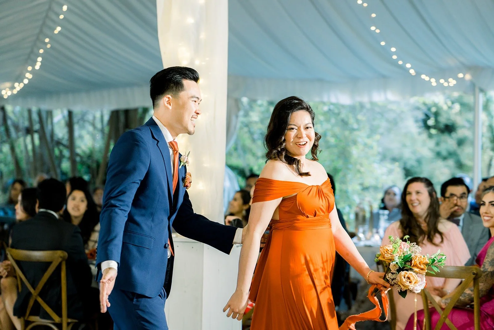 A groomsman and bridesmaid making their grand entrance