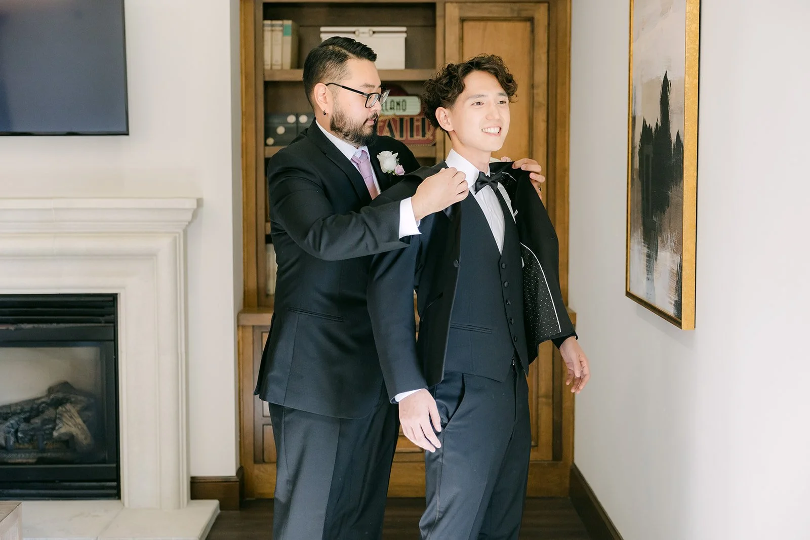 Best man adjusting Tony's boutonniere in the groom's suite at Vellano Estate
