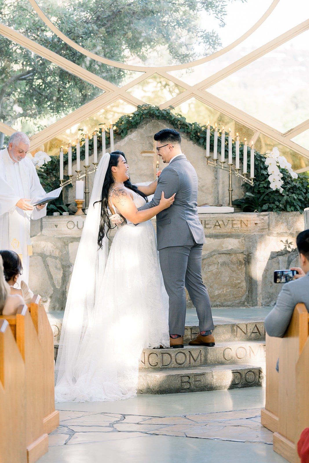 Betsy and Mikey face each other on the stone altar steps
