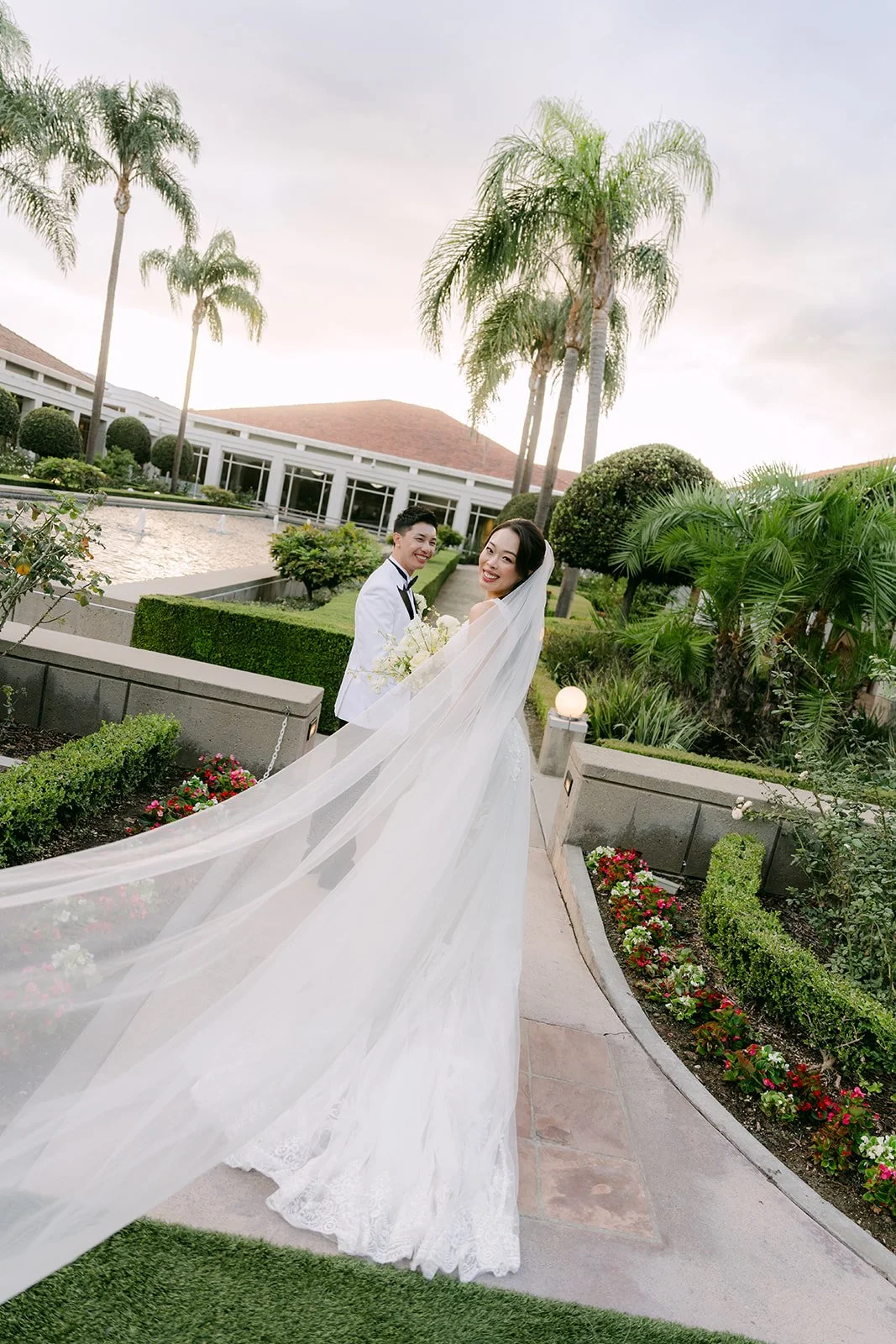 Jenny's veil sweeping across the path between the palms.