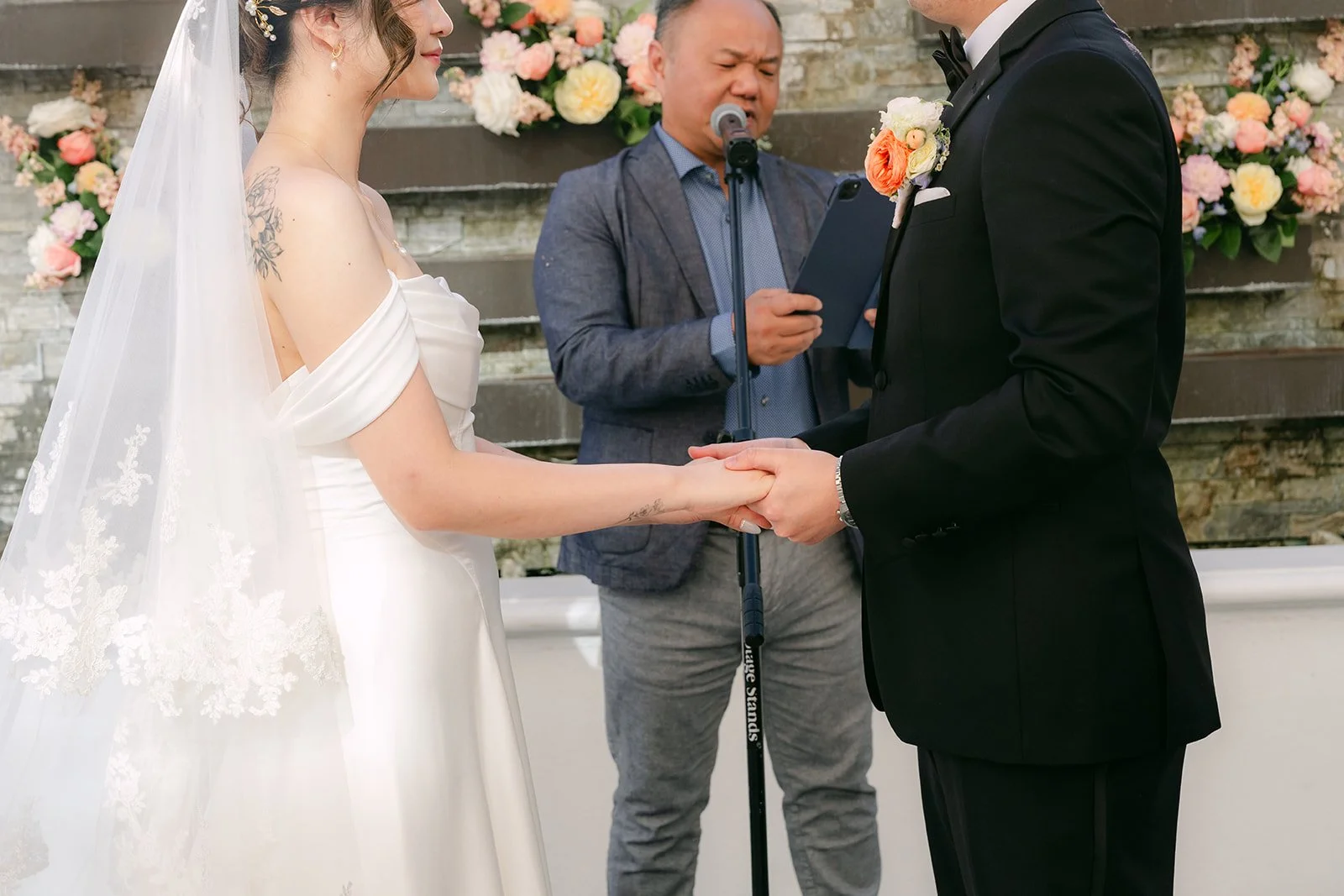 Amanda and San at the front of the ceremony with their officiant.