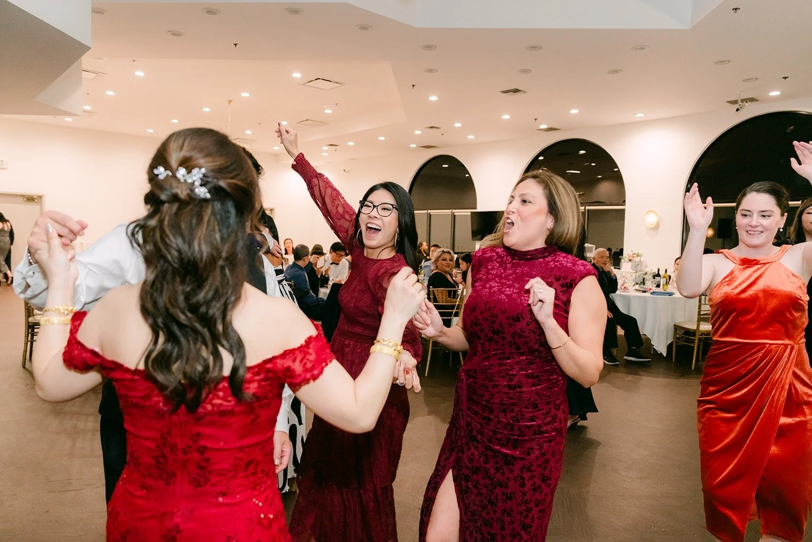 Sochi and guests dance with their hands in the air